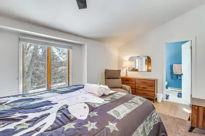a bedroom with a large bed and a window at 1 Mi to Big Boulder Mountain Townhome with Grill in Lake Harmony