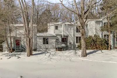 a house with snow in front of it at 1 Mi to Big Boulder Mountain Townhome with Grill in Lake Harmony