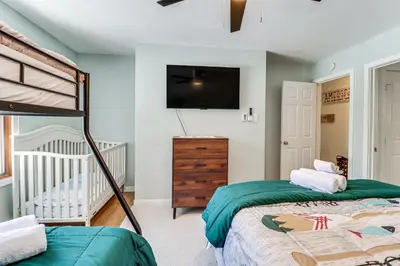 a bedroom with a bunk bed and a crib at 1 Mi to Big Boulder Mountain Townhome with Grill in Lake Harmony