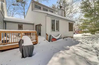 a white house with snow on the yard at 1 Mi to Big Boulder Mountain Townhome with Grill in Lake Harmony