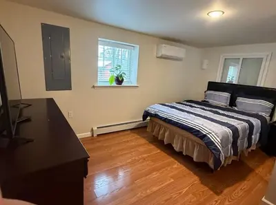 a bedroom with a bed and a desk and a window at Huge house with Game Room, Hot Tub, 3 living rooms, 2 bonus rooms in Albrightsville