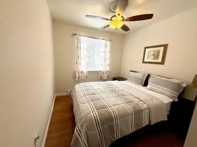 a bedroom with a bed with a ceiling fan at Huge house with Game Room, Hot Tub, 3 living rooms, 2 bonus rooms in Albrightsville