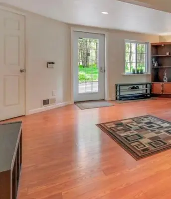 an empty living room with a hard wood floor at Huge house with Game Room, Hot Tub, 3 living rooms, 2 bonus rooms in Albrightsville