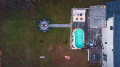 an aerial view of a yard with a swimming pool at Luxury Escape 5BR Pool HotTub Game Room FirePit in Long Pond