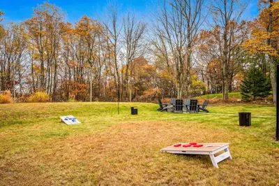 a picnic table in the middle of a field at Luxury Escape 5BR Pool HotTub Game Room FirePit in Long Pond