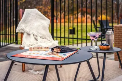 a table with a plate of food and a glass at Luxury Escape 5BR Pool HotTub Game Room FirePit in Long Pond