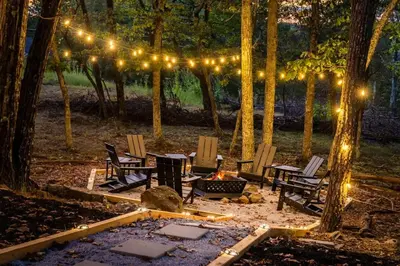 a group of chairs and a fire pit with lights at Retreat HotTub FirePit Sauna GameRm Pool Playroom in East Stroudsburg