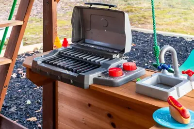 a toy grill on a table with a sink at Retreat HotTub FirePit Sauna GameRm Pool Playroom in East Stroudsburg