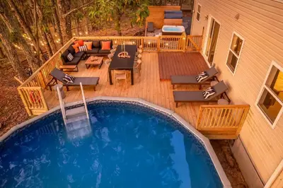 an overhead view of a swimming pool on a deck at Retreat HotTub FirePit Sauna GameRm Pool Playroom in East Stroudsburg