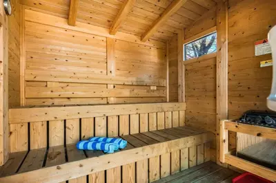 a wooden sauna with blue pillows in a cabin at 10K sqft Estate 2 Pools Pond Games Sauna Hot Tub in East Stroudsburg