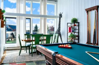 a living room with a pool table and a dining area at 10K sqft Estate 2 Pools Pond Games Sauna Hot Tub in East Stroudsburg