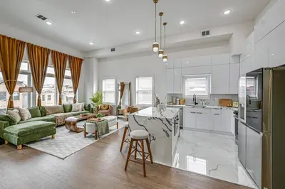 a kitchen and living room with a table and chairs at Luxe Group Getaway 6 Mi to Manhattan! in Jersey City