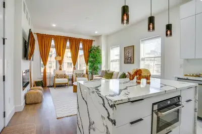 a kitchen and living room with white walls and windows at Luxe Group Getaway 6 Mi to Manhattan! in Jersey City