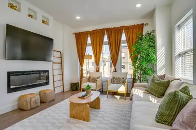 a living room with a couch and a tv at Luxe Group Getaway 6 Mi to Manhattan! in Jersey City