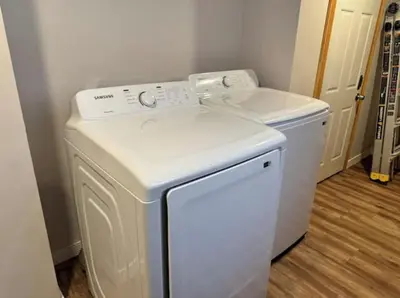 a white washer and dryer in a room at Americana in Jersey City