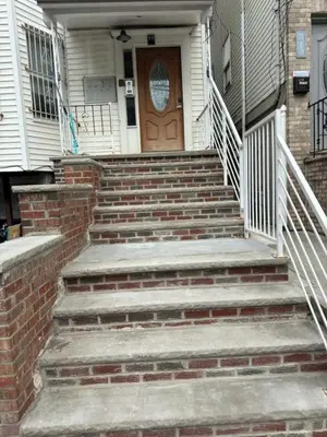 a set of stairs leading to a door of a house at Americana in Jersey City