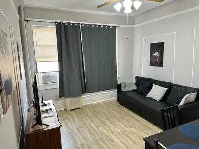 a living room with a couch and a window at Casa Yael in West New York