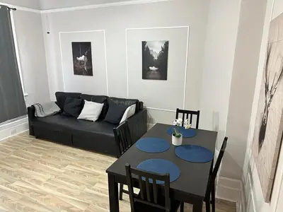a living room with a table and a couch at Casa Yael in West New York