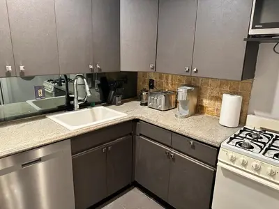 a kitchen with a sink and a stove at Casa Yael in West New York