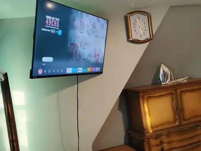 a flat screen tv hanging on a wall at Grove#1 in Irvington