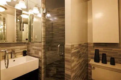 a bathroom with a sink and a mirror at Urban Oasis 1BR East Village Hideaway with Patio! in New York
