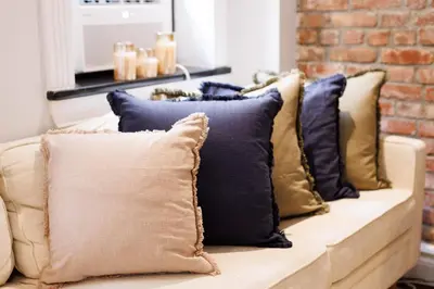 a row of pillows sitting on a couch at Urban Oasis 1BR East Village Hideaway with Patio! in New York