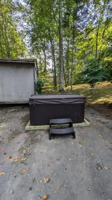 a hot tub and a bench in a parking lot at 5 min Shawnee Mountain, Hot tub, Game Rm, 3 Kings in East Stroudsburg