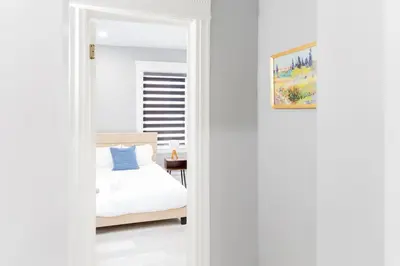a bedroom with a bed and a mirror at Spacious 3 bedrooms Apartment-20 mins to NYC in West New York