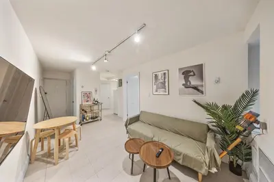 a living room with a couch and a table at The NYC Edition Times Square in New York
