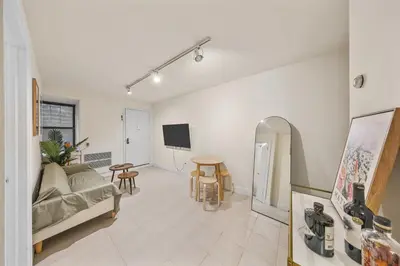 a living room with a couch and a table at The NYC Edition Times Square in New York