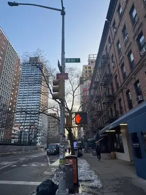 a street sign and a traffic light on a city street at Upper West Side Apartment 10 minutes walk From Central Park in New York