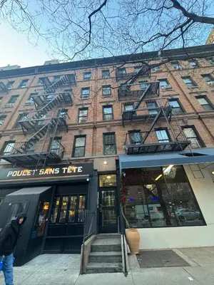 a brick building with a fire escape on it at Upper West Side Apartment 10 minutes walk From Central Park in New York