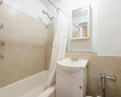 a bathroom with a sink and a tub and a mirror at Upper West Side Apartment 10 minutes walk From Central Park in New York