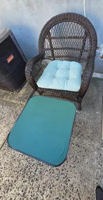a wicker chair with a mattress on the ground at Newly Built detached studio apartment with private toilet and bath in Irvington