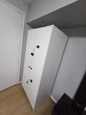 a white cabinet in the corner of a room at Renovated Room with Private Bath in Ground Floor 3BR in Irvington