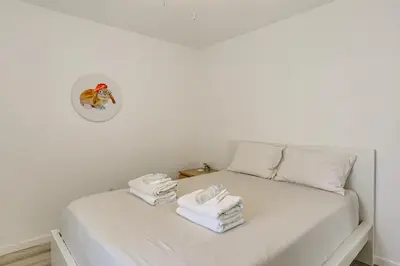 a bedroom with two beds with white sheets and towels at Game Room and Hot Tub Family Gem on Lake Hopatcong