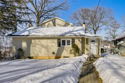 a house covered in snow with a driveway at Game Room and Hot Tub Family Gem on Lake Hopatcong