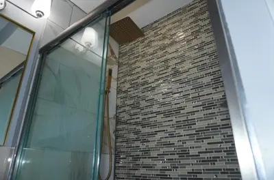 a brick wall with a glass door in a building at New York private room 29 in West New York