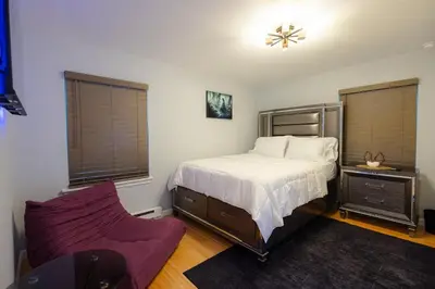 a bedroom with a bed and a purple couch at Bear Trails Retreat-Pocono Getaway Near Kalahari in Pocono Summit