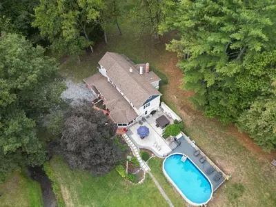 an overhead view of a house with a swimming pool at Creekside Farmstead - Pool - Hot Tub - 3 Min to Lake - Pets Allowed in Auburn