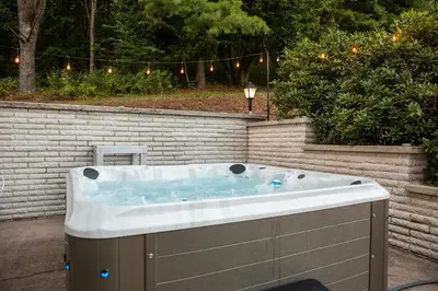 a jacuzzi tub in a backyard with lights at Creekside Farmstead - Pool - Hot Tub - 3 Min to Lake - Pets Allowed in Auburn