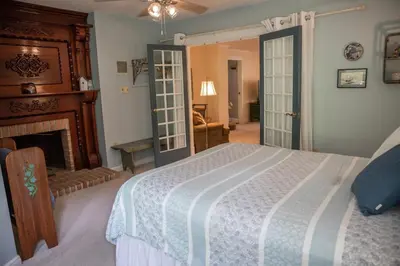 a bedroom with a bed and a fireplace at Creekside Farmstead - Pool - Hot Tub - 3 Min to Lake - Pets Allowed in Auburn