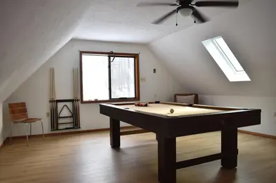 a room with a pool table in a attic at A-Frame Chalet Ski Lodge Near Shawnee in East Stroudsburg
