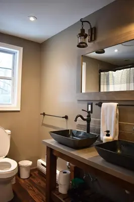 a bathroom with two sinks and a toilet at A-Frame Chalet Ski Lodge Near Shawnee in East Stroudsburg