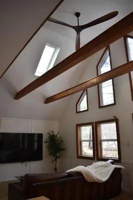 a living room with a ceiling fan and windows at A-Frame Chalet Ski Lodge Near Shawnee in East Stroudsburg