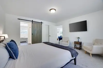a bedroom with a large bed and a television at The Aerie House in Blakeslee