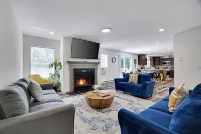 a living room with blue couches and a fireplace at The Aerie House in Blakeslee