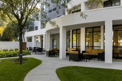 a building with tables and chairs in a courtyard at Courtyard by Marriott Harrisburg West Mechanicsburg in Mechanicsburg