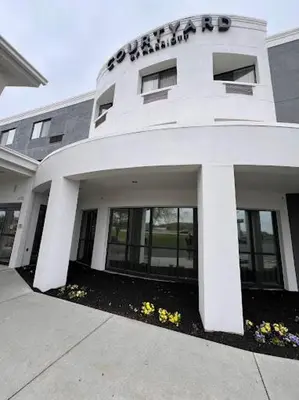 a white building with a sign on top of it at Courtyard by Marriott Harrisburg West Mechanicsburg in Mechanicsburg