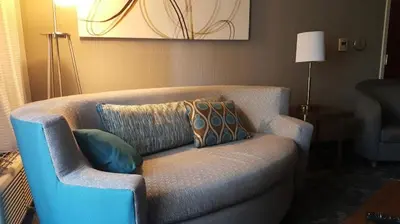 a living room with a couch with pillows on it at Courtyard by Marriott Harrisburg West Mechanicsburg in Mechanicsburg